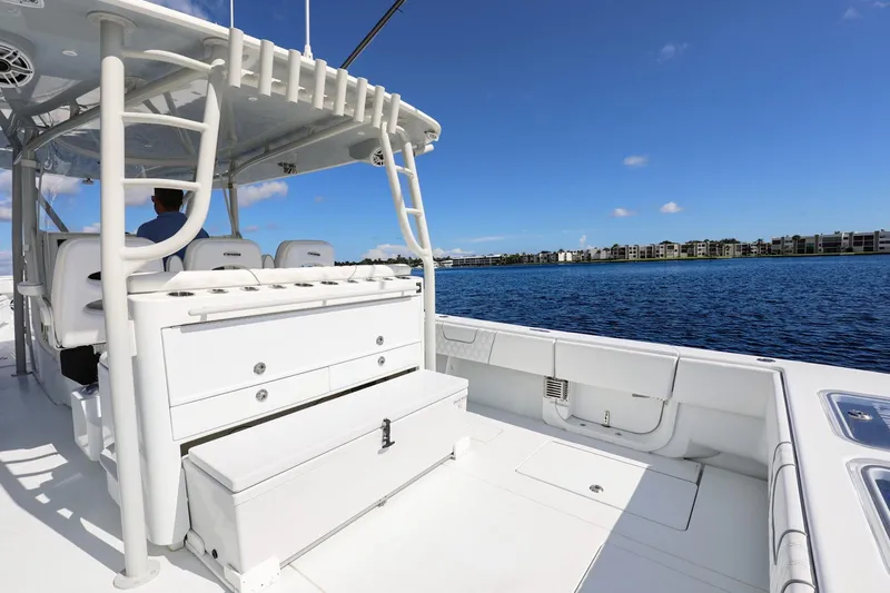 Slide: The Image of 2023 Contender 44 ST boat on calm water, featuring spacious deck and seating. - 19