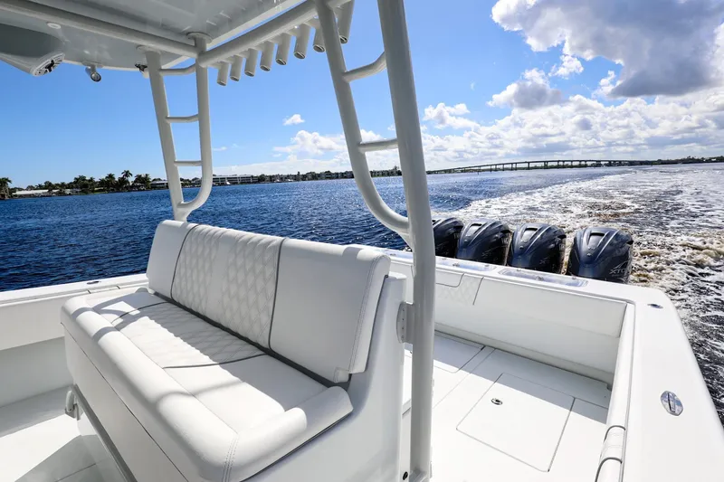 Slide: The Image of 2023 Contender 44 ST boat with powerful engines cruising on a sunny day. - 21