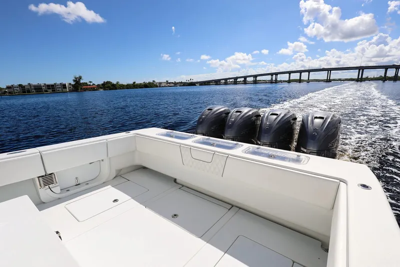 Slide: The Image of 2023 Contender 44 ST boat cruising on a sunny day with four powerful engines. - 24