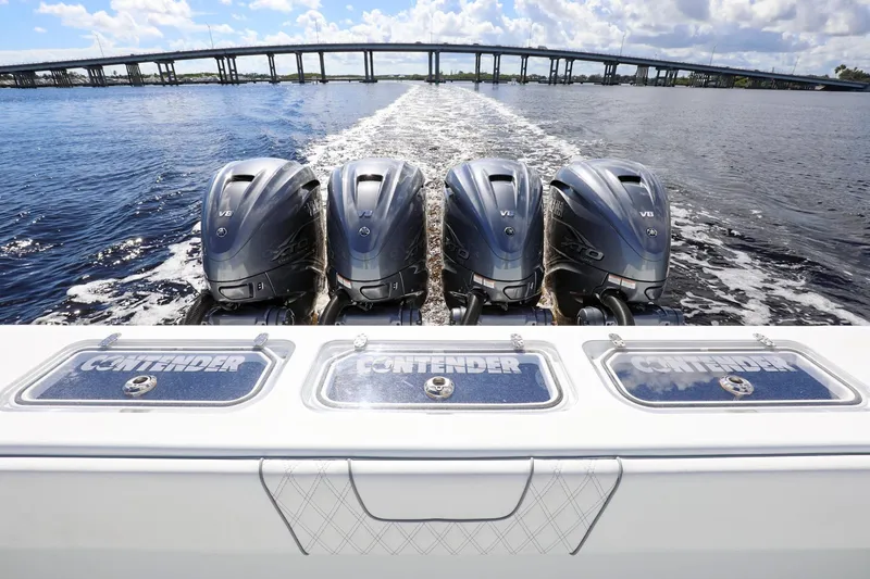 Slide: The Image of 2023 Contender 44 ST boat with four powerful outboard engines on open water. - 25