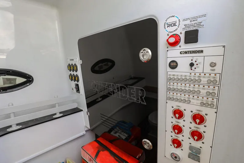 Slide: The Image of 2023 Contender 44 ST boat control panel with switches and safety equipment. - 29