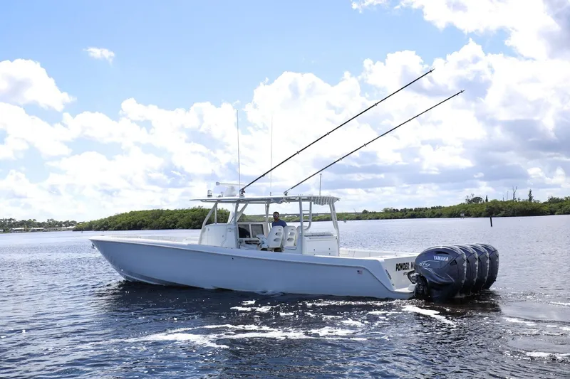 Slide: The Image of 2023 Contender 44 ST boat with Yamaha engines on a sunny day. - 3