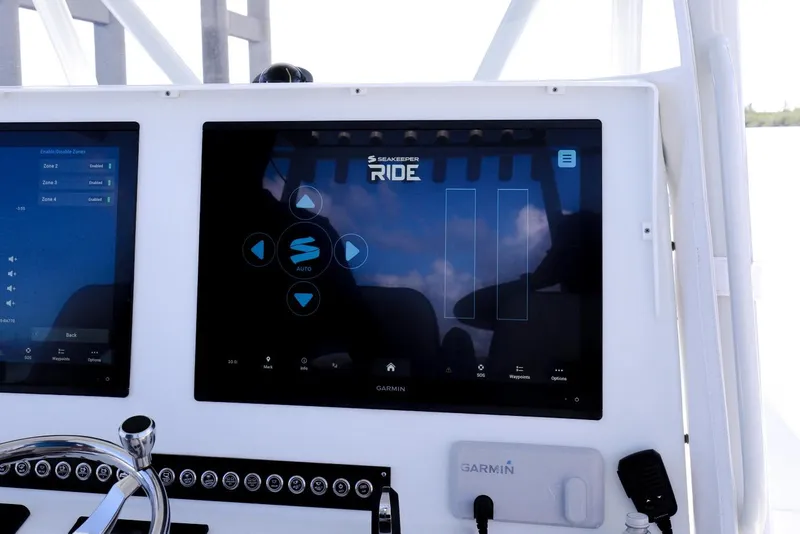 Slide: The Image of 2023 Contender 44 ST boat dashboard with Seakeeper Ride and Garmin displays. - 32