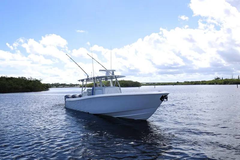 Slide: The Image of 2023 Contender 44 ST boat on calm water under a bright blue sky. - 4