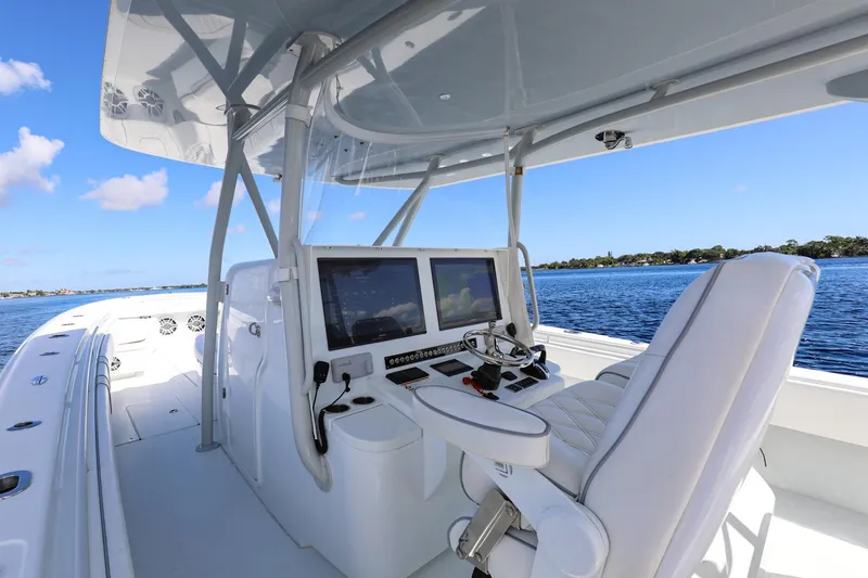 Slide: The Image of 2023 Contender 44 ST boat interior with advanced navigation system on a sunny day. - 7