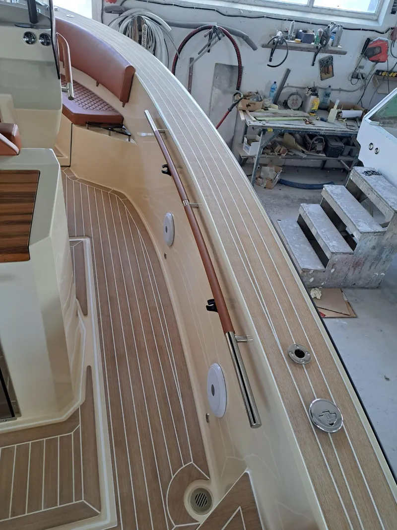 Slide: The Image of 2025 Lilybaeum Levanzo 25 Lounge Deck boat interior with wood finish and seating. - 14