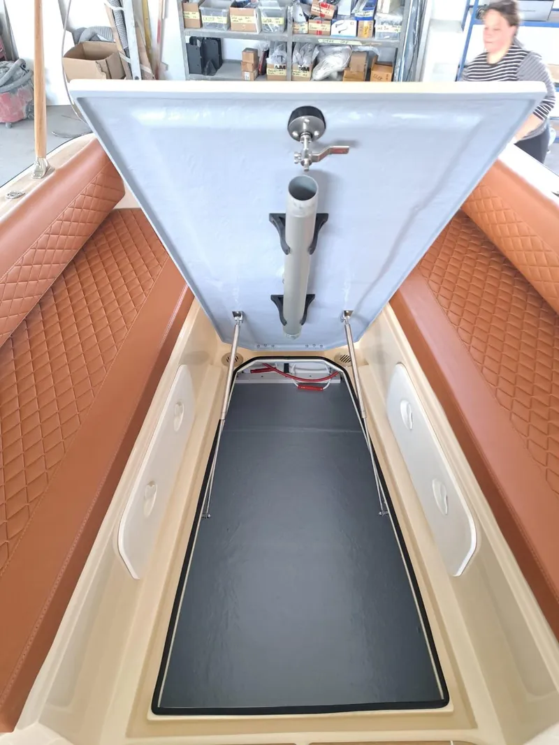 Slide: The Image of 2025 Lilybaeum Levanzo 25 Lounge Deck interior with open storage compartment and quilted seating. - 26