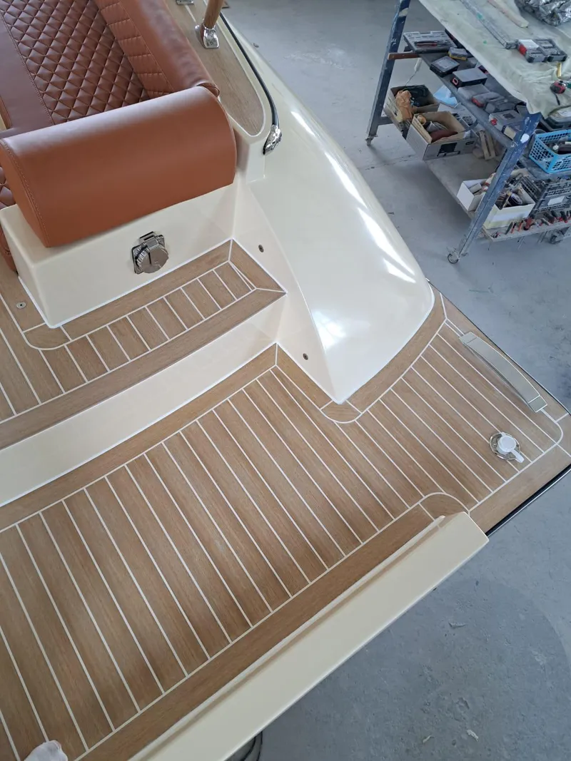 Slide: The Image of Luxury deck of 2025 Lilybaeum Levanzo 25 Lounge, featuring elegant wood finish and leather seating. - 27