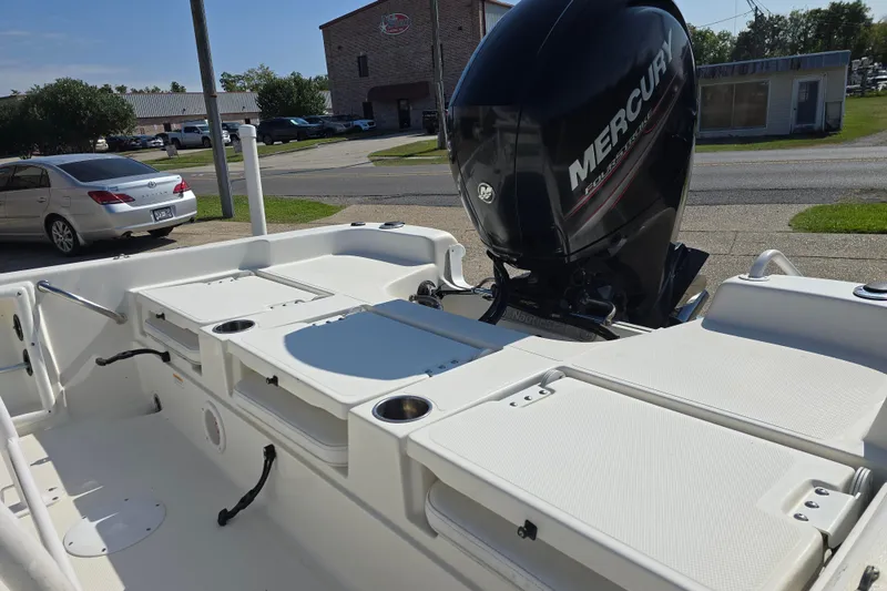 Slide: The Image of 2014 NauticStar 214 XTS Shallow Bay boat with Mercury engine, parked outdoors. - 11