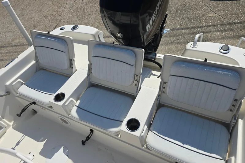Slide: The Image of 2014 NauticStar 214 XTS Shallow Bay boat seats with cup holders and engine view. - 12