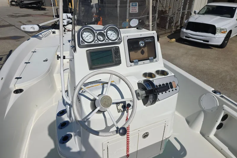 Slide: The Image of 2014 NauticStar 214 XTS Shallow Bay boat dashboard with steering wheel and gauges. - 13