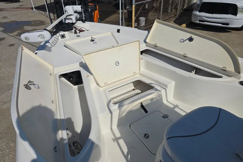 Slide: The Image of 2014 NauticStar 214 XTS Shallow Bay boat with open storage compartments. - 16