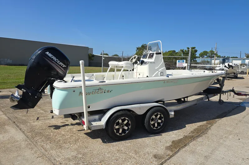 Slide: The Image of 2014 NauticStar 214 XTS Shallow Bay boat on trailer with Mercury outboard motor. - 5