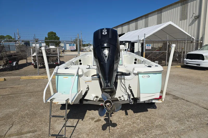 Slide: The Image of 2014 NauticStar 214 XTS Shallow Bay boat with outboard motor, parked outdoors. - 6