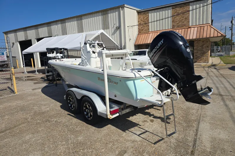Slide: The Image of 2014 NauticStar 214 XTS Shallow Bay boat on trailer with Mercury outboard motor. - 7