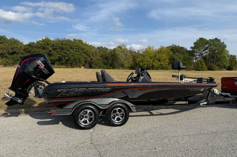 Slide: The Image of 2019 Nitro Z21 Pro boat on trailer, parked outdoors under a clear sky. - 32