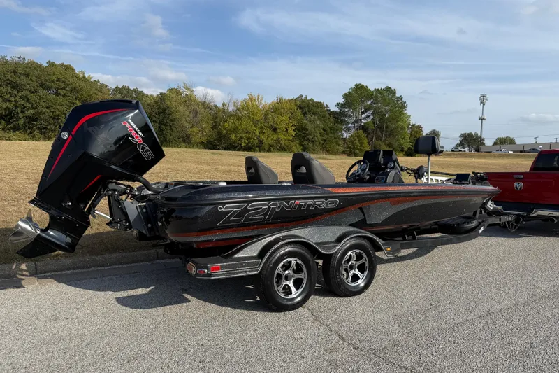 Slide: The Image of 2019 Nitro Z21 Pro bass boat on trailer, parked outdoors under clear sky. - 33