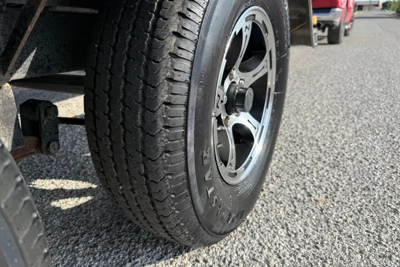 Slide: The Image of Close-up of a 2019 Nitro Z21 Pro trailer tire on a textured road surface. - 37