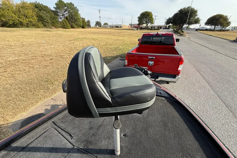 Slide: The Image of 2019 Nitro Z21 Pro boat seat with red truck in background on a sunny day. - 42