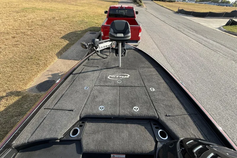 Slide: The Image of 2019 Nitro Z21 Pro boat on trailer, parked near a red truck. - 43