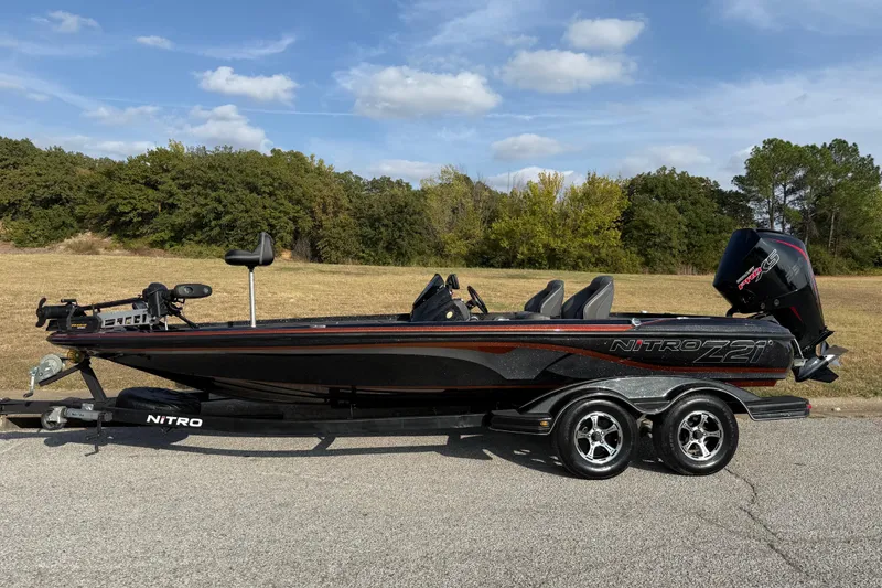 Slide: The Image of 2019 Nitro Z21 Pro bass boat on trailer, parked on roadside. - 5