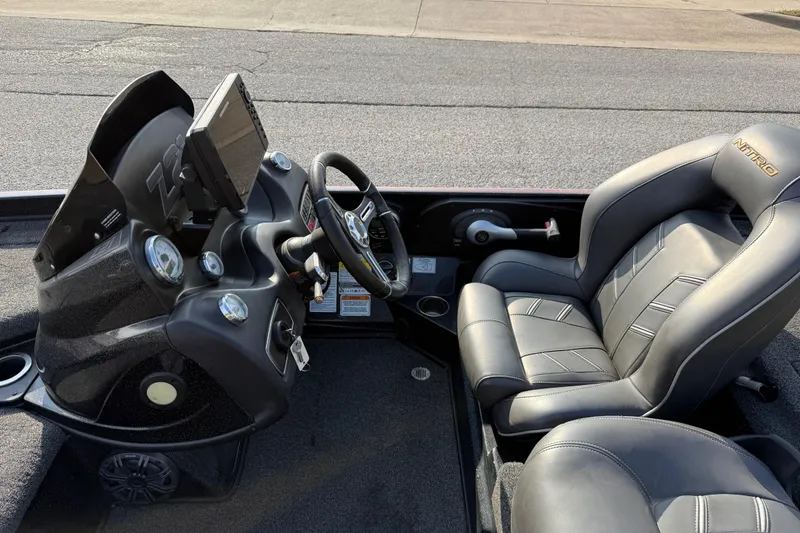 Slide: The Image of 2019 Nitro Z21 Pro boat interior with steering console and cushioned seats. - 57