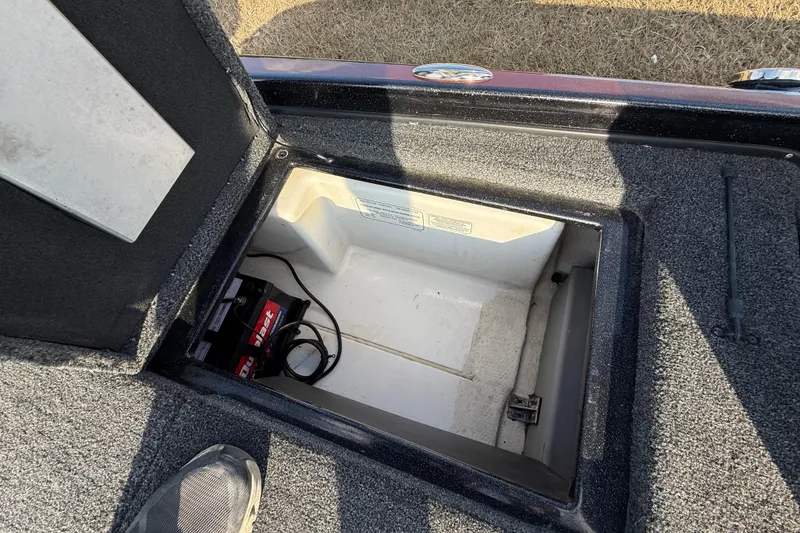 Slide: The Image of Open storage compartment in 2019 Nitro Z21 Pro boat, showing battery and cables. - 65