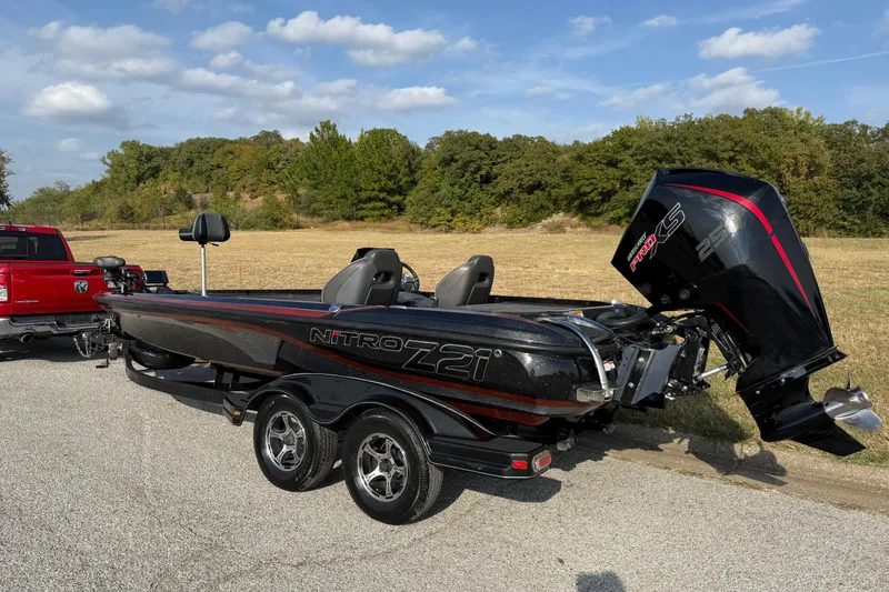 Slide: The Image of 2019 Nitro Z21 Pro bass boat on trailer, parked outdoors. - 8