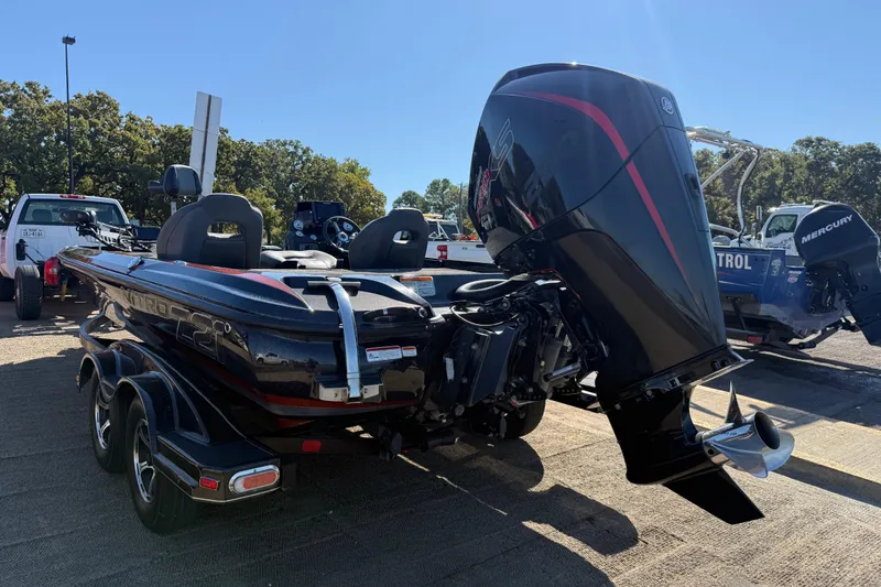 Slide: The Image of 2019 Nitro Z21 Pro bass boat with powerful outboard motor in a parking area. - 86