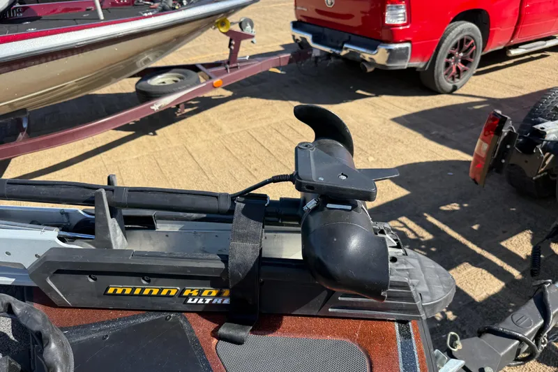 Slide: The Image of 2019 Nitro Z21 Pro with Minn Kota Ultrex trolling motor, parked near a red truck. - 92