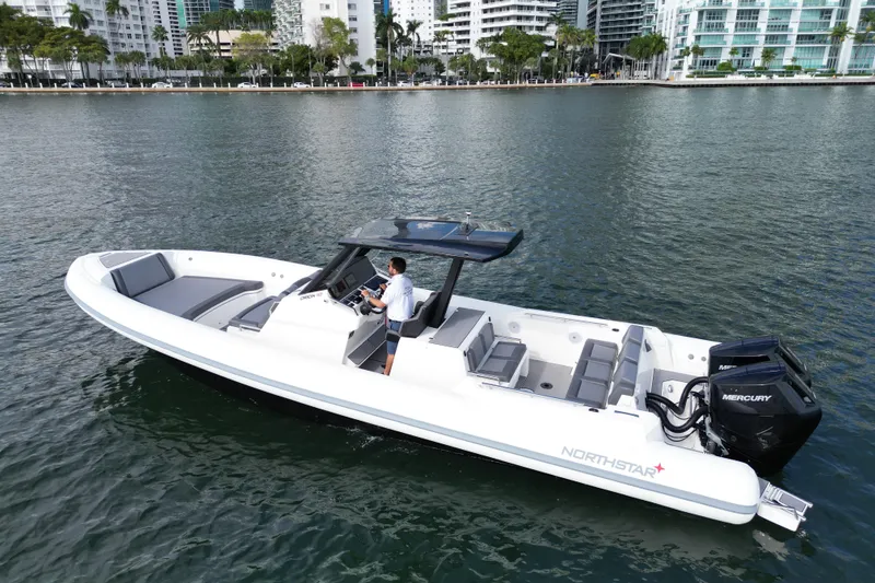 The Image of 2026 Northstar ORION 10 boat cruising on water near cityscape. - 0