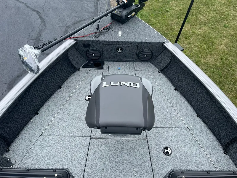 Slide: The Image of 2026 Lund 1775 Impact XS Sport boat interior with seating and fishing equipment. - 13
