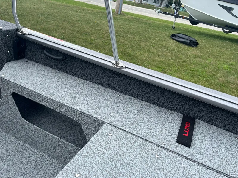 Slide: The Image of 2026 Lund 1775 Impact XS Sport boat interior with textured flooring and handle. - 19