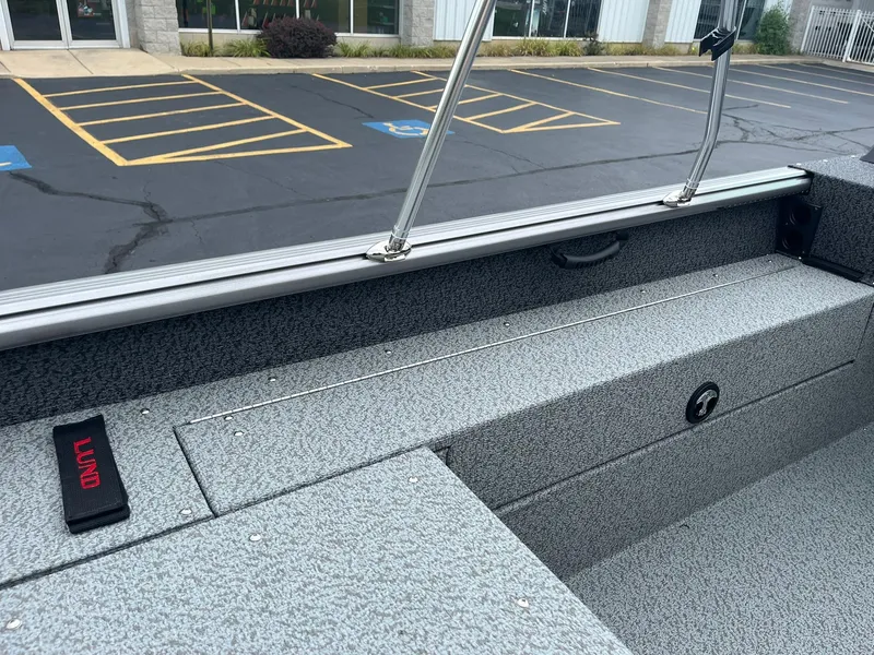 Slide: The Image of 2026 Lund 1775 Impact XS Sport boat interior with gray textured flooring and seating. - 20
