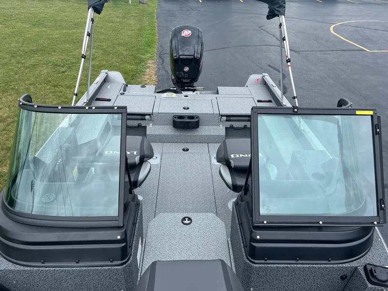 Slide: The Image of 2026 Lund 1775 Impact XS Sport boat with dual windshields and outboard motor. - 21