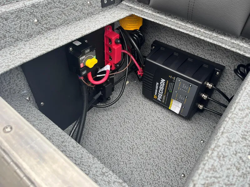 Slide: The Image of Electrical components inside a 2026 Lund 1775 Impact XS Sport boat. - 27
