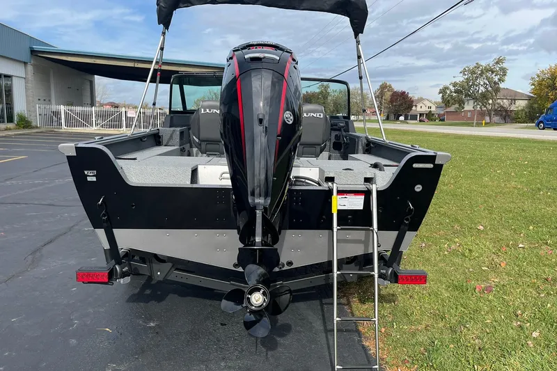 Slide: The Image of 2026 Lund 1775 Impact XS Sport boat, rear view with motor and ladder. - 3