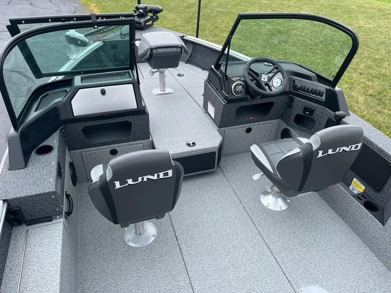 Slide: The Image of 2026 Lund 1775 Impact XS Sport boat interior with dual seats and steering console. - 6