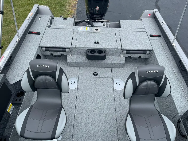 Slide: The Image of 2026 Lund 1775 Impact XS Sport boat interior with gray seating and storage compartments. - 7