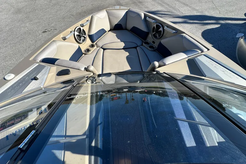 Slide: The Image of 2018 Malibu Wakesetter 23 LSV boat interior with seating and cup holders. - 11