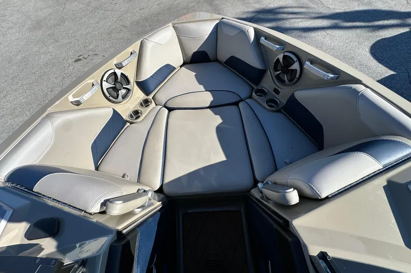 Slide: The Image of 2018 Malibu Wakesetter 23 LSV boat interior with cushioned seating and cup holders. - 12