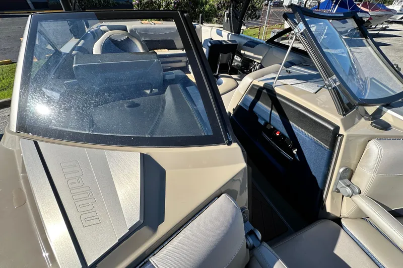 Slide: The Image of 2018 Malibu Wakesetter 23 LSV interior with open windshield and seating area. - 14