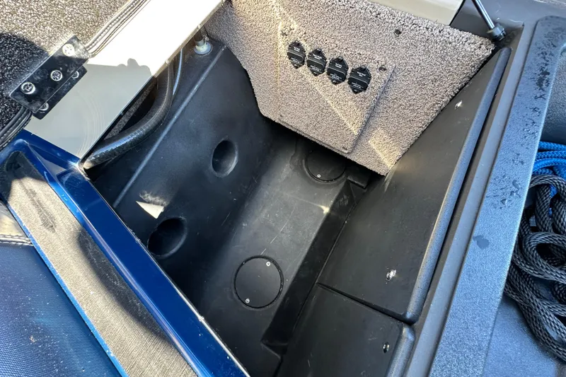 Slide: The Image of 2018 Malibu Wakesetter 23 LSV storage compartment with carpeted interior and control panel. - 20