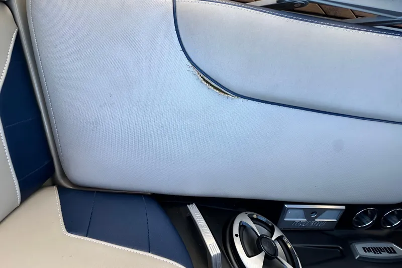 Slide: The Image of 2018 Malibu Wakesetter 23 LSV interior with torn upholstery and speaker detail. - 21