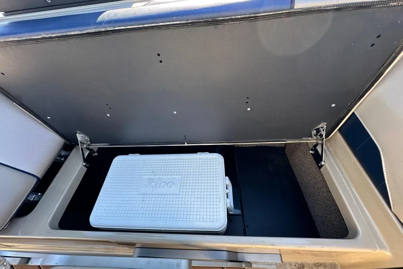 Slide: The Image of 2018 Malibu Wakesetter 23 LSV storage compartment with Igloo cooler inside. - 23