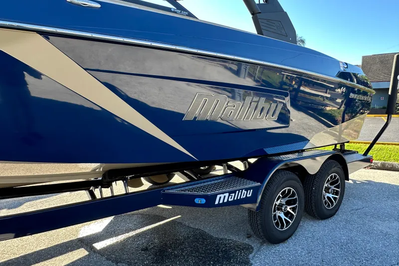 Slide: The Image of 2018 Malibu Wakesetter 23 LSV boat on trailer, blue and beige design. - 6