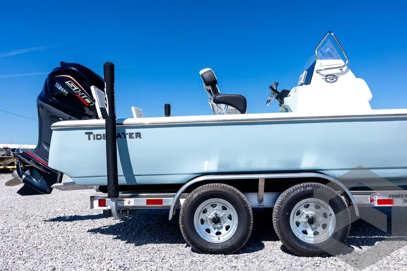 Slide: The Image of 2026 Tidewater 2110 Bay Max boat on trailer, featuring Yamaha engine, under clear blue sky. - 13