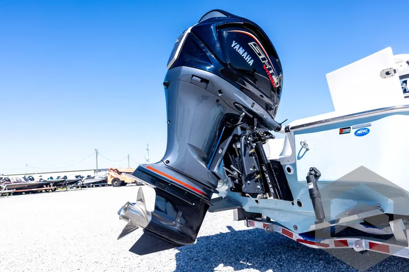 Slide: The Image of 2026 Tidewater 2110 Bay Max boat with Yamaha outboard motor, displayed outdoors. - 16