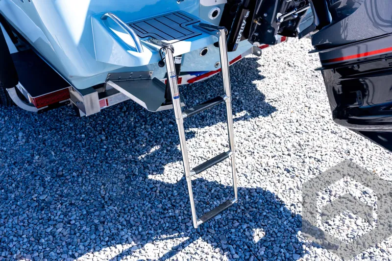 Slide: The Image of 2026 Tidewater 2110 Bay Max boat with ladder on gravel surface. - 24