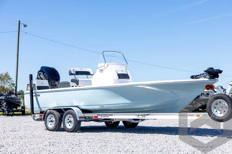 Slide: The Image of 2026 Tidewater 2110 Bay Max boat on trailer, parked outdoors on gravel. - 3